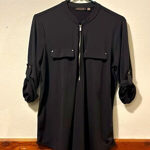 Woman’s black FYLO half zip top with roll up and roll down sleeves. Size M